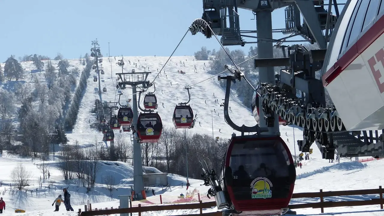 Gondeln der Ettelsberg-Seilbahn über der verschneiten Piste